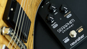 Neunaber Seraphim Shimmer pedal next to a guitar