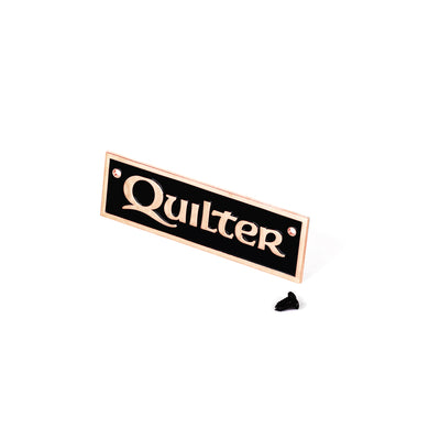 Quilter badge in copper shown with 2 screws