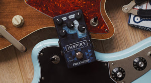 Neunaber Inspire Pedal atop two guitars on a table
